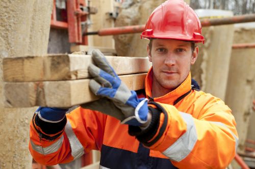 Builder carrying planks