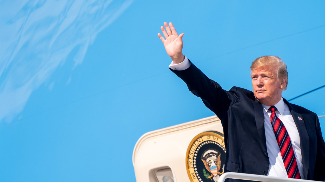 Donald Trump waves from the steps of Air Force One