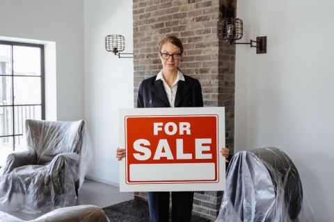 Agent with for sale sign