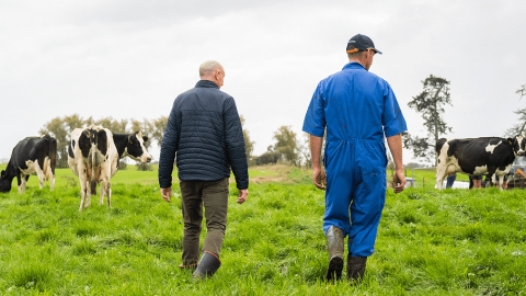 Banker and farmer on farm